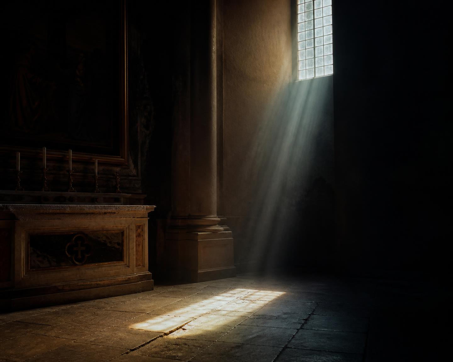 Morning light falling through a high window onto the worn limestone floor of an old church.
